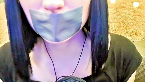 Asian woman with black hair tape-gagged in ASMR BDSM setup
