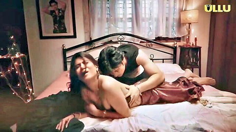 Shirtless man fucking topless Indian MILF missionary with big tits exposed on bed