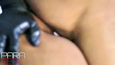 Ebony MILF in black latex gloves teasing her curves in steamy black porn video