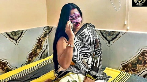 Masked Indian woman in sexy black saree on phone, seductive pose