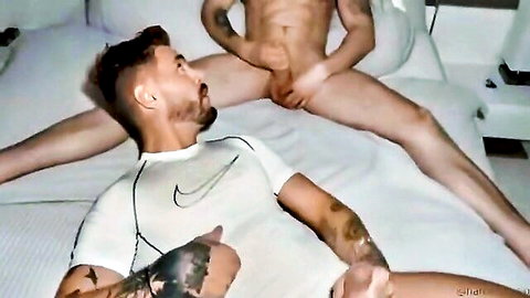 Muscular tattooed gay man masturbating solo in white Nike shirt