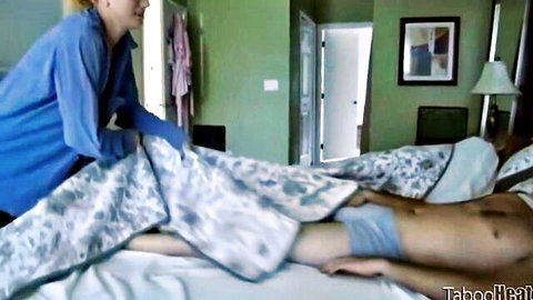 JC Simpson tucking sheet over young man in underwear in bed, daddy-daughter roleplay