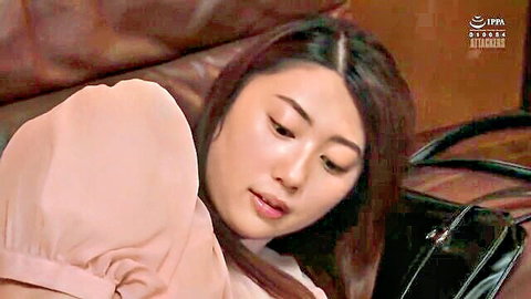 Natsu Hanabuchi as seductive Japanese office lady in pink blouse, lying provocatively, JAV scene