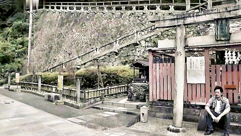 Man sitting relaxed near torii gate at Japanese shrine in vintage sepia photo