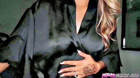 Blonde MILF in open black silk robe flashes deep cleavage and tattooed hand with wedding ring