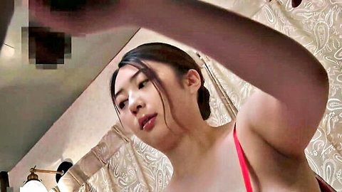 POV of busty Asian babe teasing big tits slipping red top in shower