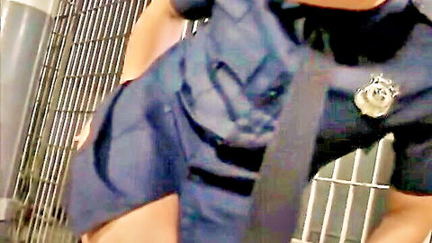 Sexy police officer in tight uniform badge flashing in jail cell bars