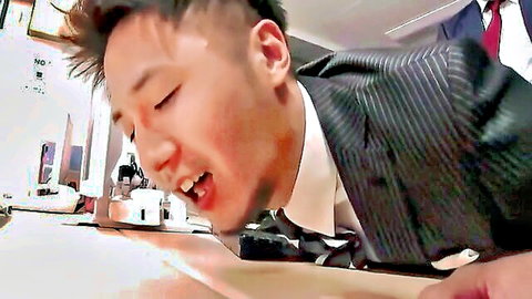 Asian guy in suit leaning forward with open mouth for hot gay oral action