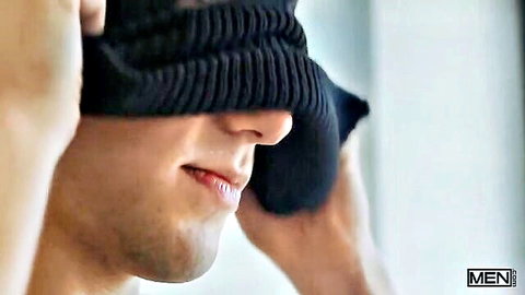 Joey Mills blindfolding himself with black beanie, shirtless gay porn thumbnail