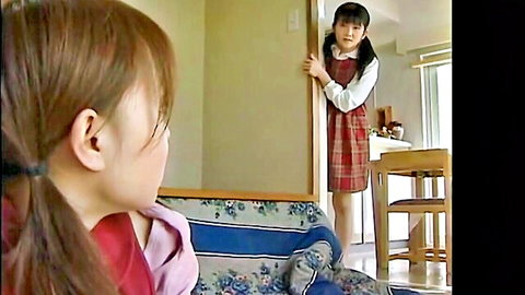 Petite Japanese schoolgirl in plaid skirt peeks seductively through doorway