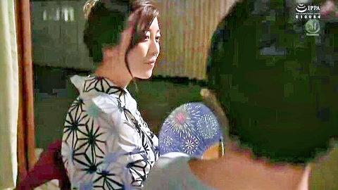 Asian beauty in kimono holding blue fan smiling seductively at man