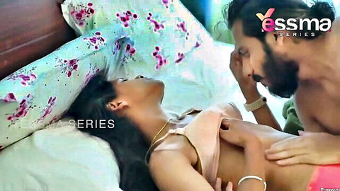 Indian MILF in pink top kissed passionately by bearded lover on bed