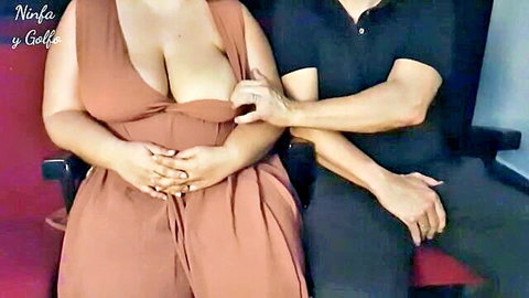 Busty curvy MILF in deep cleavage dress groped by man's hand on her huge tits