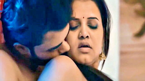 Busty Indian MILF passionately kissed on neck by bearded hunk groping her bare tits