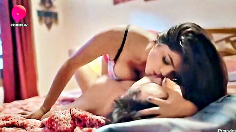 Indian brunette with massive tits in black bra passionately kissing shirtless guy on bed
