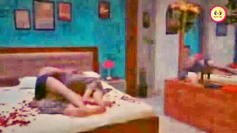 Seductive Indian stepmom in shorts on bed with rose petals, solo pose HD porn