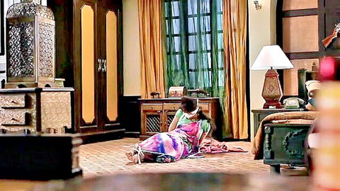 Bound Indian woman in colorful sari, gagged in BDSM scene