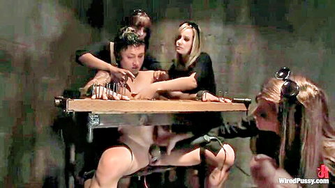 Femdom women in black torment bound naked man's exposed cock and balls with needles in BDSM dungeon