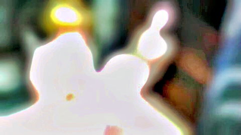 Blurry abstract glowing white shapes with yellow halos on dark background