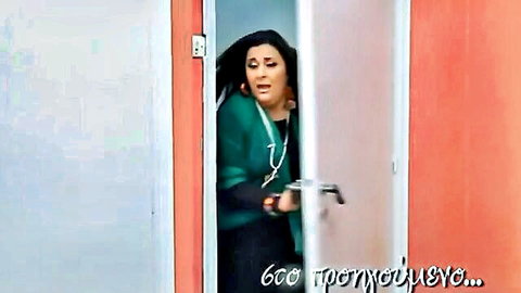 Brunette woman in green sweater opening pink door, BDSM tease