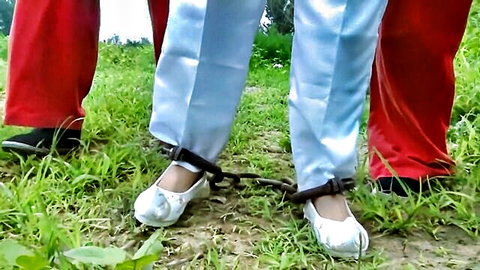 Ancient Chinese prisoner BDSM: Asian women in white and red outfits shackled outdoors