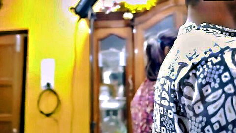 Indian man between two sexy women in saree standing by bedroom mirror teasing threesome