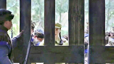 Chinese woman with braids in green hat, BDSM uniform scene behind bars