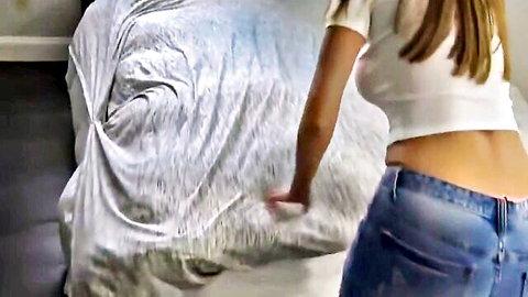 Brunette babe in tight jeans bends over bed teasing her sexy ass