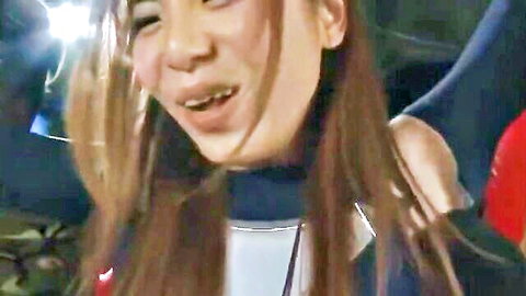 Smiling Japanese heroine in sexy BDSM outfit with stockings on stage