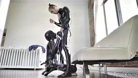 Latex dominatrix with ponytail motivates hooded sub in intense BDSM blowjob with vibrator