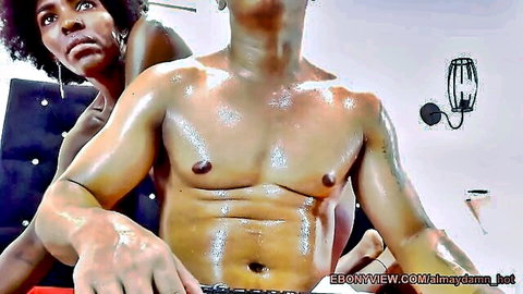 Oiled muscular ebony man embraced by curvy black woman in amateur sex scene
