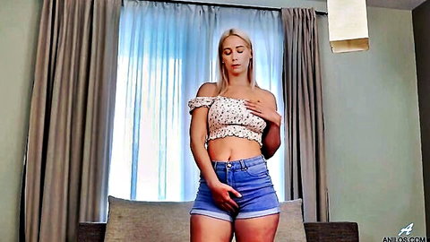 Busty blonde Sharon White teases solo, hands on breasts and crotch in crop top and shorts
