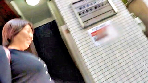 Mature Japanese wife smiling seductively in black button-up top, JAV preview
