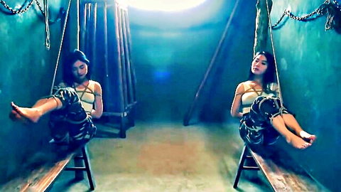 Twin Asian women bound in chains and ropes, gagged BDSM pose