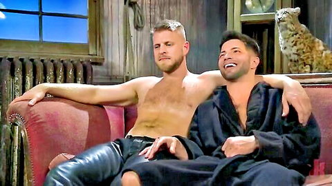 Two muscular men cuddling intimately, one shirtless in leather pants, other in robe, gay thumbnail