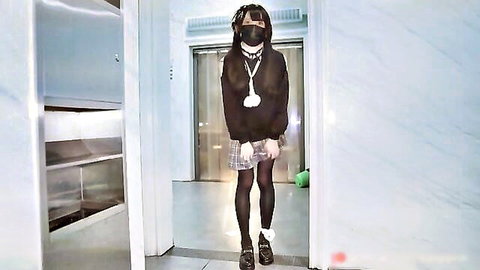 Asian transvestite in plaid skirt, black hoodie, stockings, small tits tease