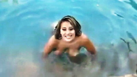 Selena Castro topless in pool, big tits wet and smiling seductively