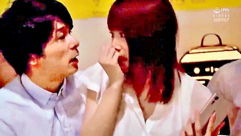 Japanese man whispers intimately to redhead woman touching her face in office tease