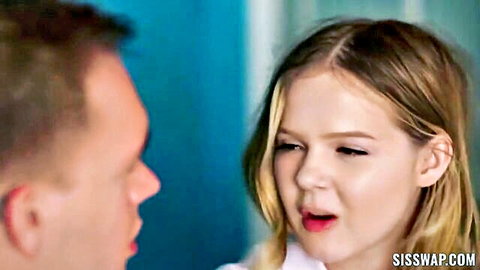 Blonde teen with open glossy lips stares intensely at man in intimate closeup