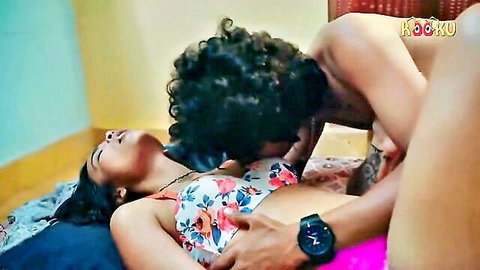 Indian man with curly hair passionately kissing brunette South Asian woman's neck grabbing her big tits