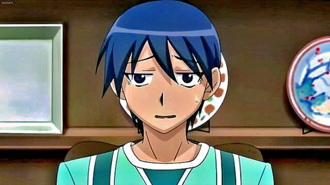 Blue-haired anime boy in green tracksuit looking surprised and sweating at kitchen table