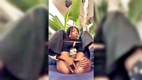 Ebony beauty in provocative flash pose, legs spread wide in black outfit