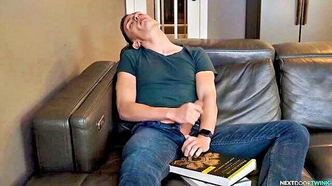 Young twink lounging relaxed with hand teasing crotch over jeans
