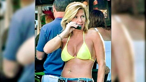 Busty blonde MILF in skimpy yellow bikini on phone call
