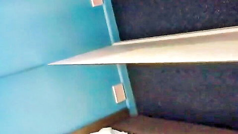Amateur homemade bedroom corner with turquoise walls dark carpet white shelf and bed sheets
