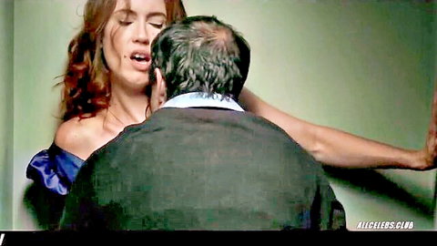 Carla Sánchez in blue off-shoulder dress, passionately neck-kissed by older man from behind