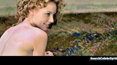 Connie Nielsen nude back view smiling over shoulder in Devil's Advocate 1997