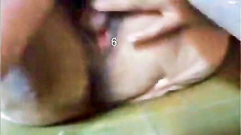 Close-up of mature East Asian woman's hairy pussy spread wide open by fingers showing wet pink vagina