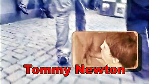 Tommy Newton close-up portrait with open mouth on public cobblestone street background