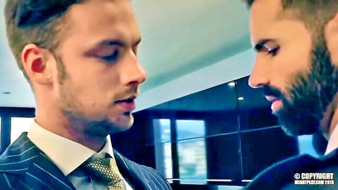 Damon Heart and Dani Robles in suits, intense close-up gay porn tease